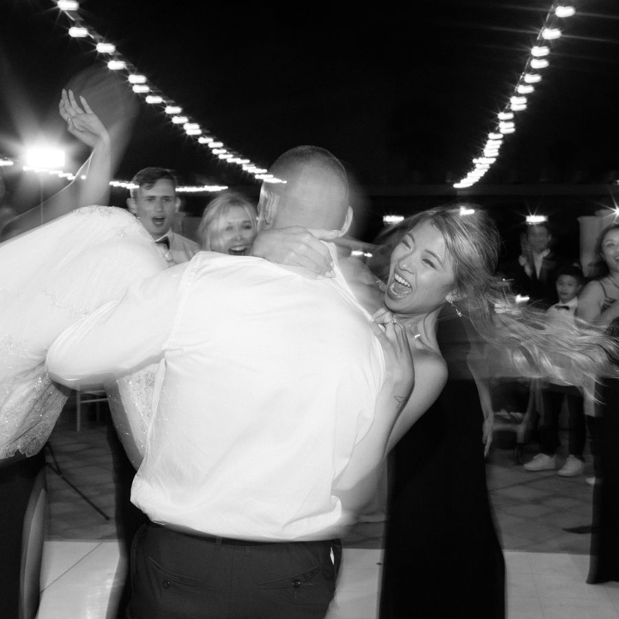 Groom spinning bride on the dance floor